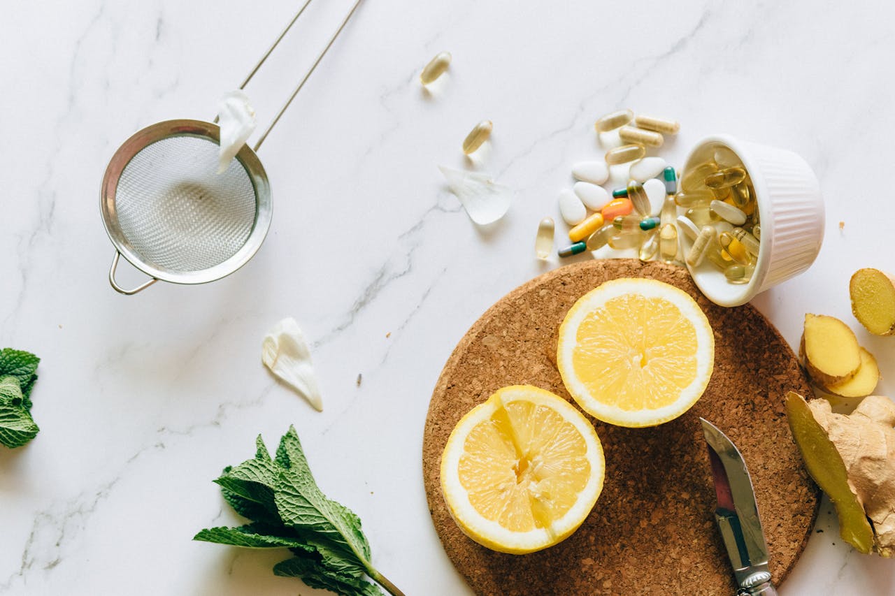 why-choose-us Flat lay of lemon, ginger, and supplements on a marble surface, illustrating natural remedies.